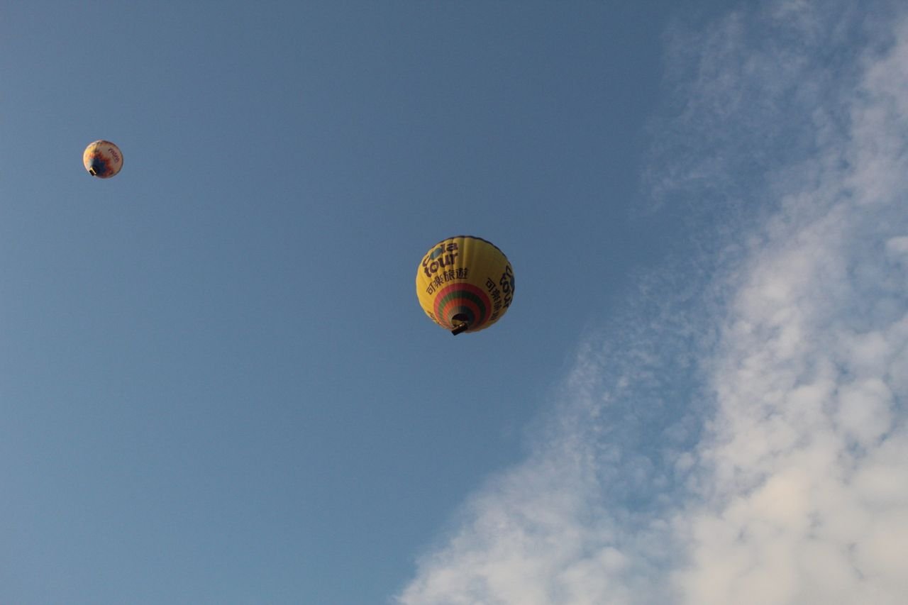 Vibrant hot air balloons soaring in the clear blue sky, symbolizing freedom and adventure.